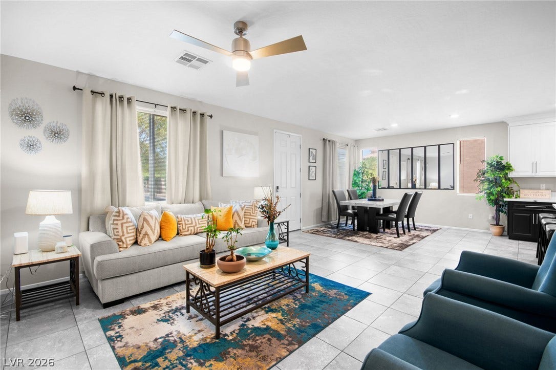 7224 Halo Falls Street, North Las Vegas, NV 89084 An inviting open-concept living and dining area features neutral tones, tile flooring, and ample natural light.