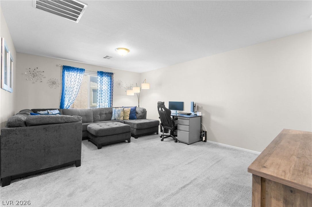 7224 Halo Falls Street, North Las Vegas, NV 89084 A spacious living room offering comfort and functionality, perfect for relaxation or work.
