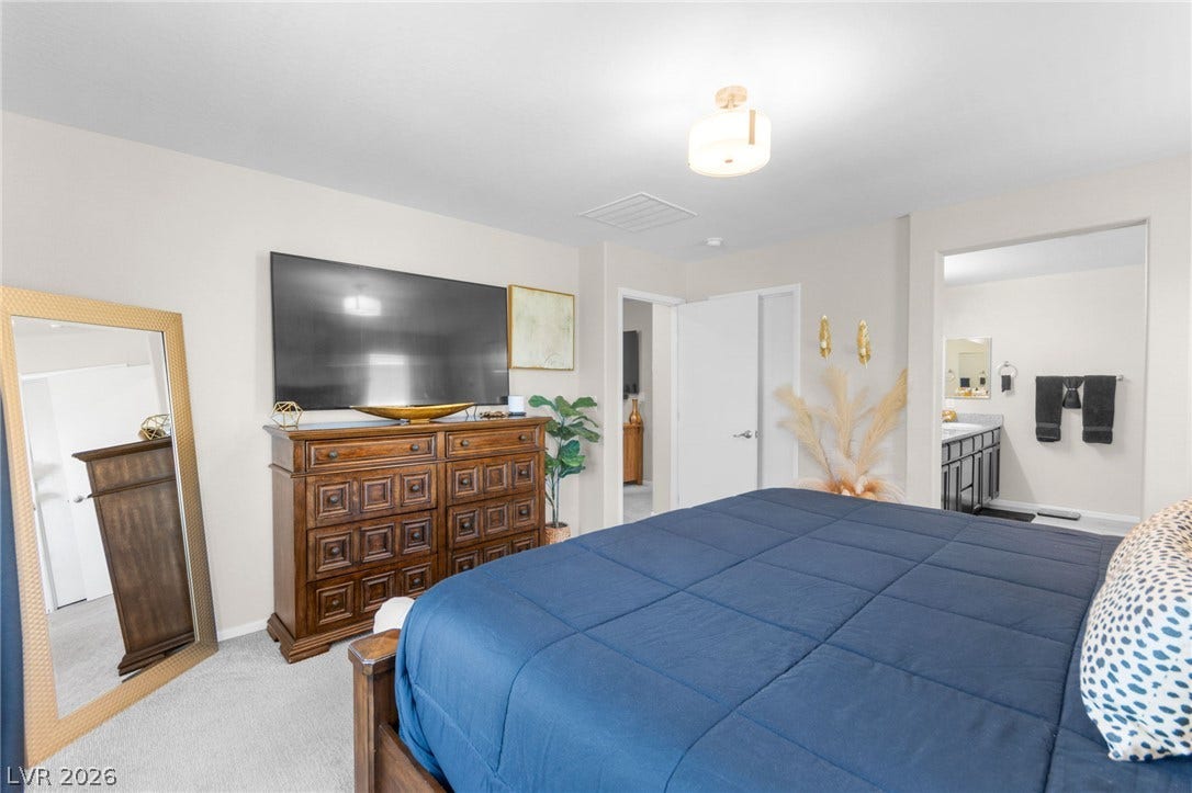7224 Halo Falls Street, North Las Vegas, NV 89084 Plush carpeting defines this inviting bedroom, complemented by a convenient en-suite bathroom.