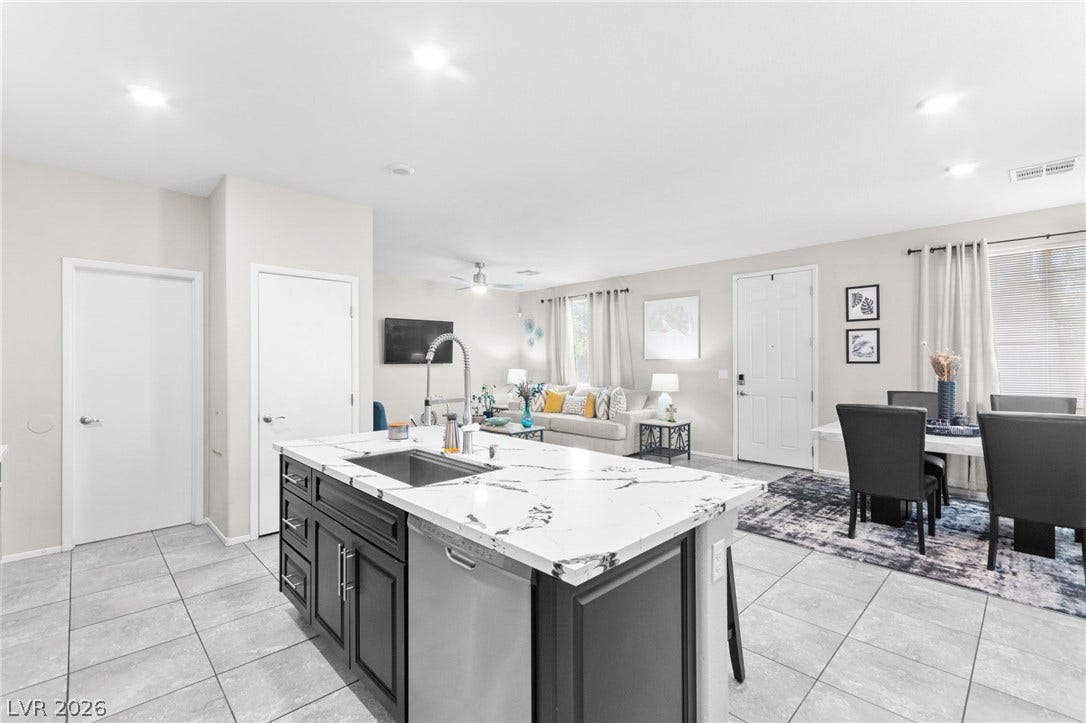 7224 Halo Falls Street, North Las Vegas, NV 89084 A central island anchors this combined kitchen, dining, and living area, ideal for open-concept living.