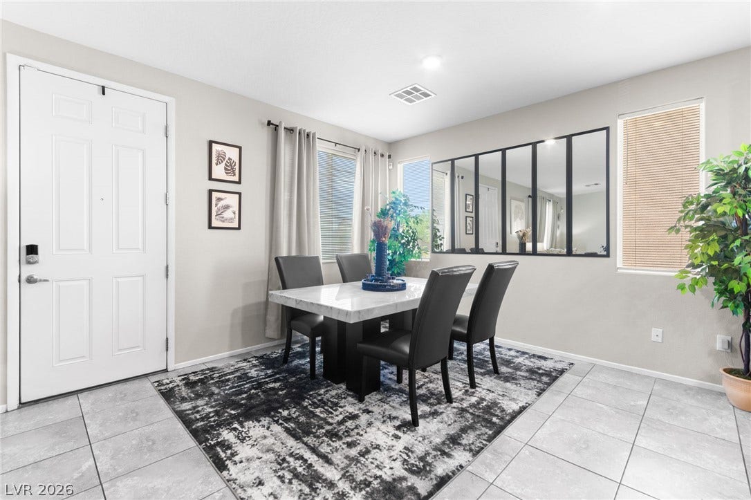 7224 Halo Falls Street, North Las Vegas, NV 89084 A well-lit dining area featuring a modern table, seating, and easy-care tile flooring.