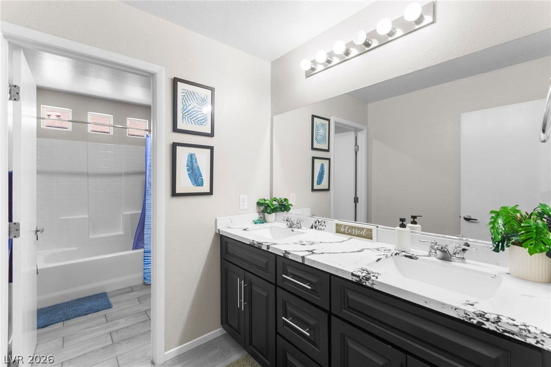 7224 Halo Falls Street, North Las Vegas, NV 89084 Dual vanities with elegant marble countertops provide ample space in this well-appointed bathroom.