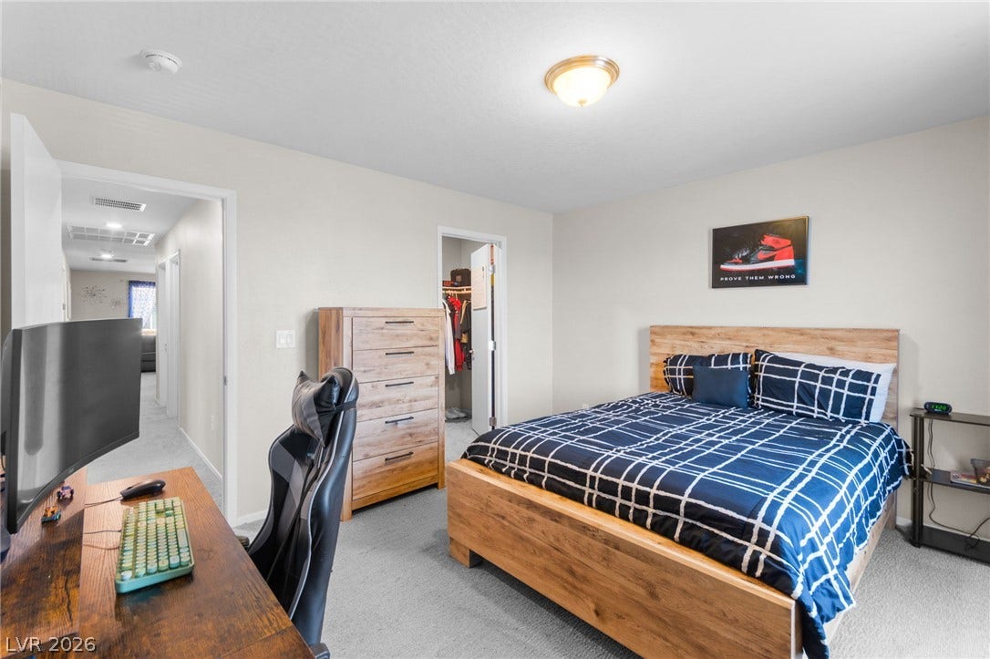 7224 Halo Falls Street, North Las Vegas, NV 89084 Well-lit bedroom with soft carpet flooring and an open doorway.