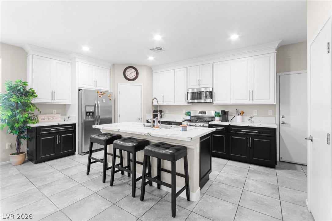 7224 Halo Falls Street, North Las Vegas, NV 89084 Culinary excellence awaits in this well-appointed kitchen, featuring a central island and abundant cabinet space.
