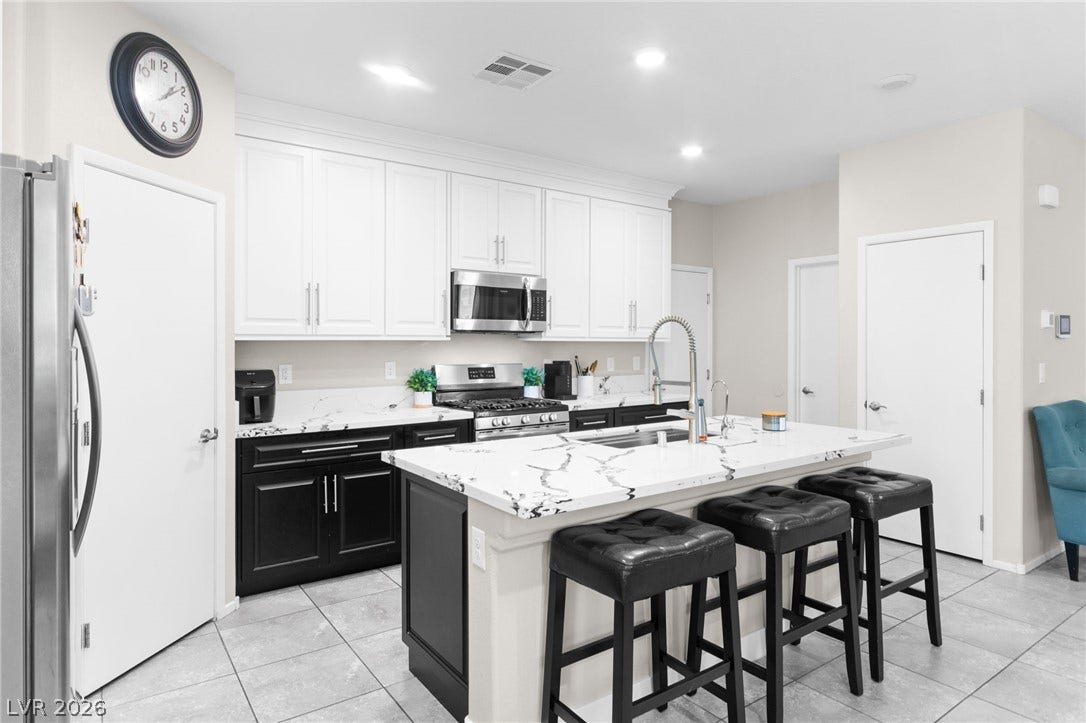 7224 Halo Falls Street, North Las Vegas, NV 89084 A well-appointed kitchen showcasing contemporary design with a central island for casual dining.