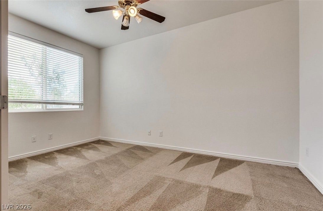 4709 Estate Ranch Street, North Las Vegas, NV 89031 Well-lit room featuring soft carpet and a window with Venetian blinds, ready for personalization.