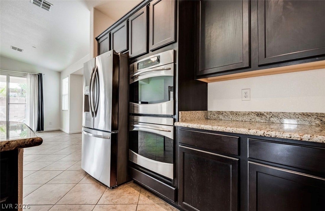 4709 Estate Ranch Street, North Las Vegas, NV 89031 Culinary aspirations find a home in this well-appointed kitchen featuring sleek appliances and ample counter space.
