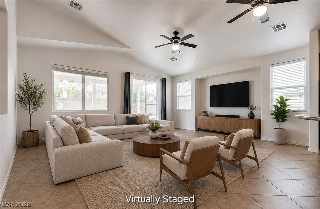 4709 Estate Ranch Street, North Las Vegas, NV 89031 An airy living room with vaulted ceilings features abundant natural light and direct backyard access.