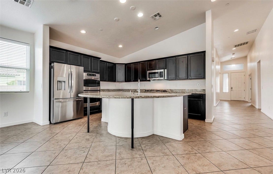 4709 Estate Ranch Street, North Las Vegas, NV 89031 Culinary aspirations come alive in this kitchen, featuring an elegant island and stainless steel appliances.
