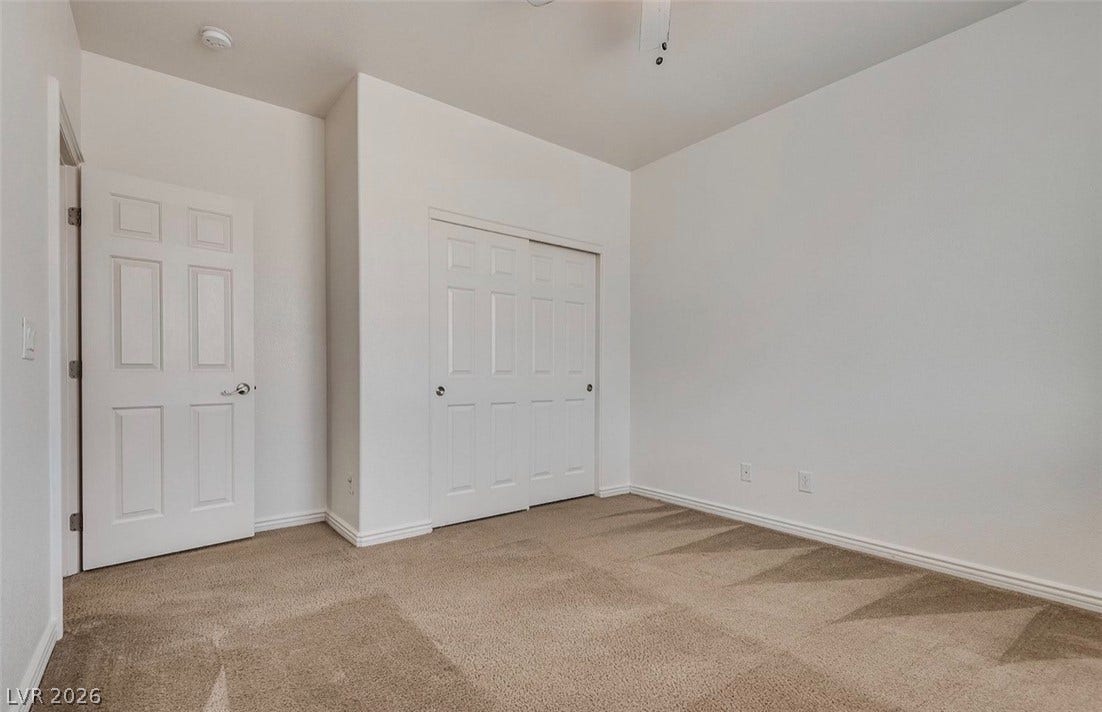 4709 Estate Ranch Street, North Las Vegas, NV 89031 Comfortable bedroom features soft carpeting and ample closet space for effortless organization.