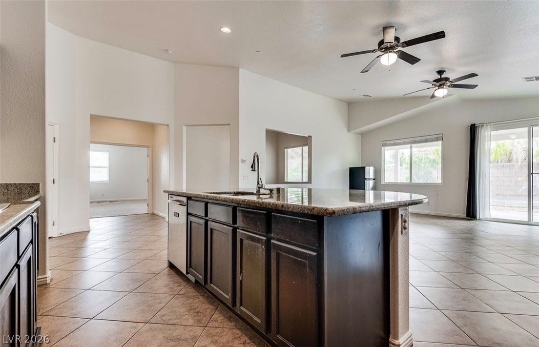 4709 Estate Ranch Street, North Las Vegas, NV 89031 A generous kitchen island provides ample counter space in this open-concept living area.