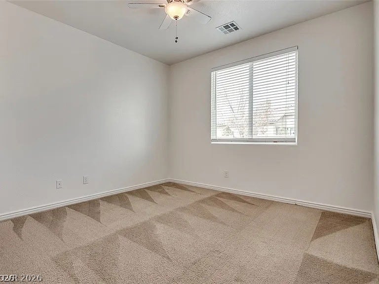 4709 Estate Ranch Street, North Las Vegas, NV 89031 A well-proportioned bedroom with patterned carpeting awaits personalization.