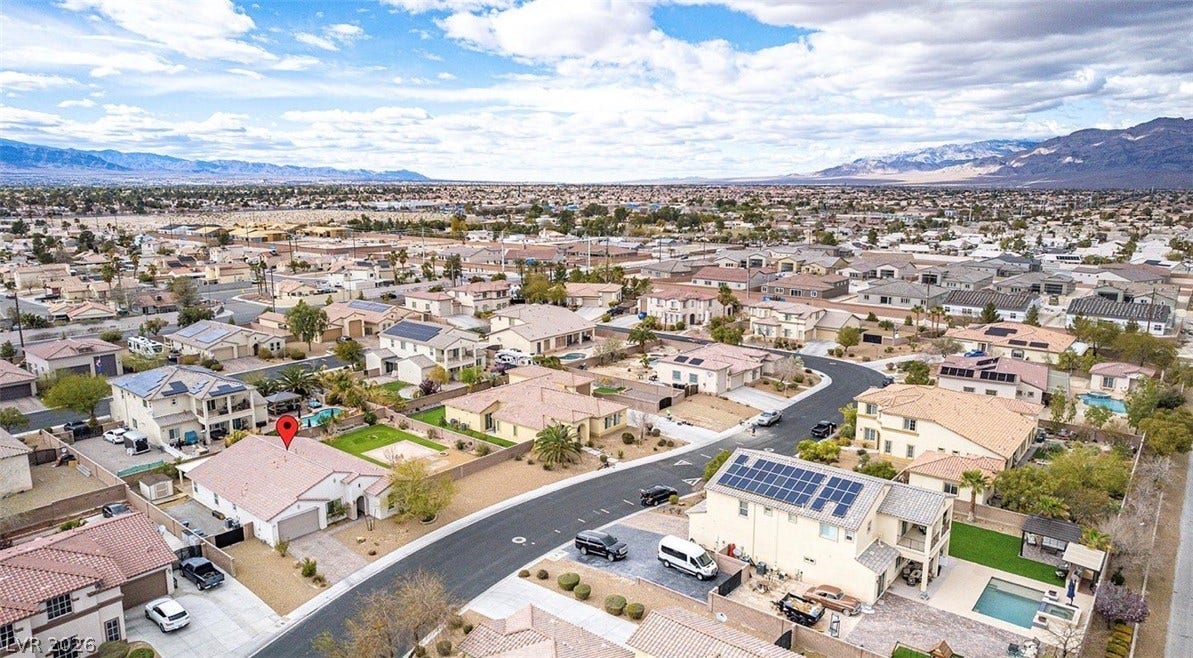 4709 Estate Ranch Street, North Las Vegas, NV 89031 An aerial perspective reveals a well-planned neighborhood nestled against a majestic mountain range.