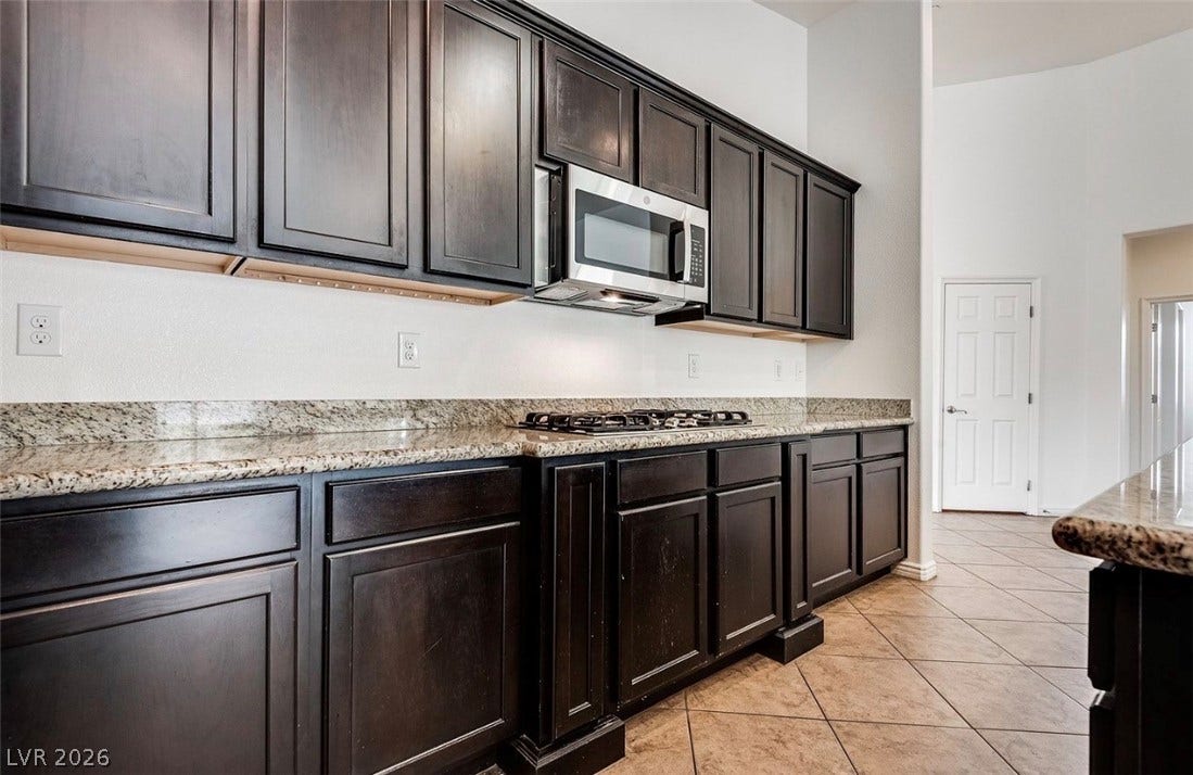 4709 Estate Ranch Street, North Las Vegas, NV 89031 Ample cabinetry and stone counters define this well-appointed culinary space.