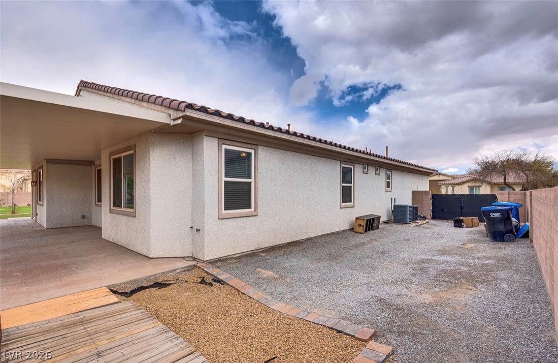 4709 Estate Ranch Street, North Las Vegas, NV 89031 A spacious gravel and paved backyard area features a large covered patio.