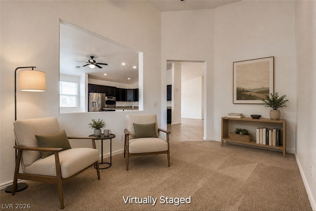 4709 Estate Ranch Street, North Las Vegas, NV 89031 A well-lit sitting area with a view into the kitchen, creating an open and connected living space.