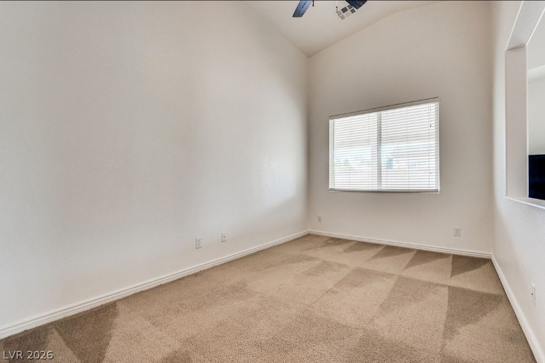 4709 Estate Ranch Street, North Las Vegas, NV 89031 A well-lit bedroom offering vaulted ceilings and soft carpeting, ready for personalization.