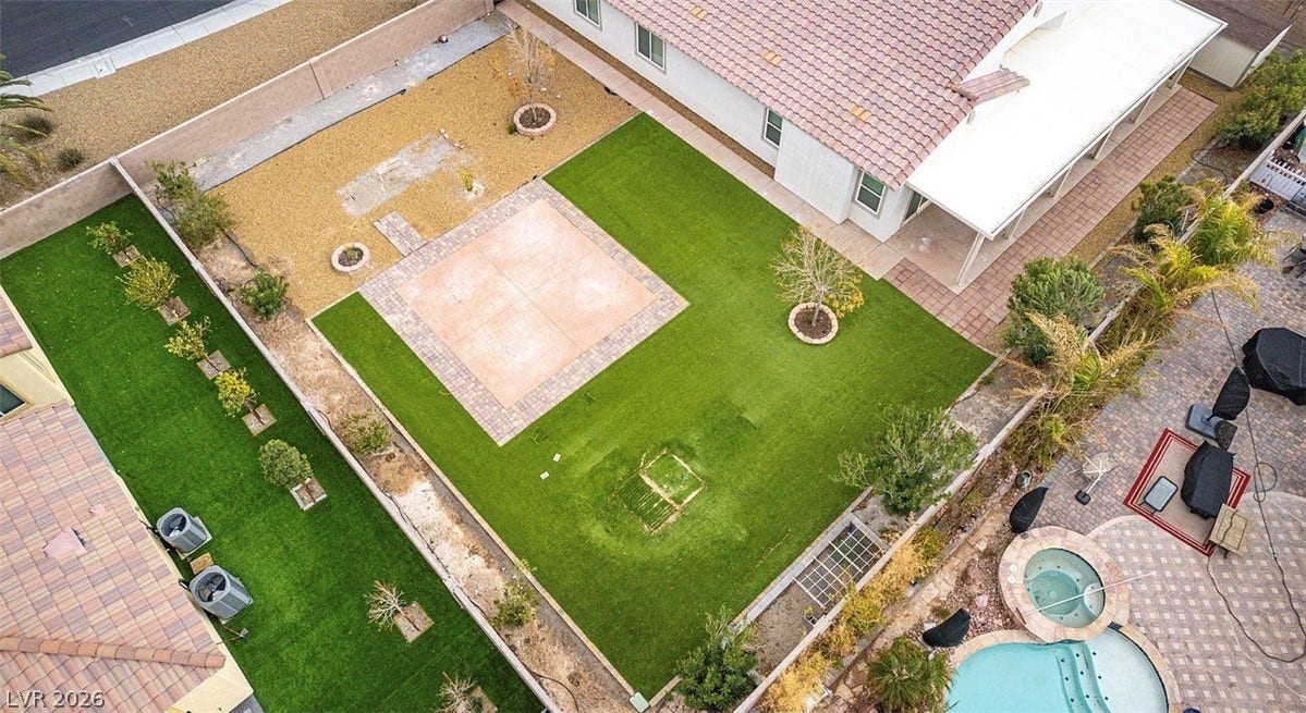 4709 Estate Ranch Street, North Las Vegas, NV 89031 A spacious backyard presents both paved and turfed areas for versatile outdoor enjoyment.
