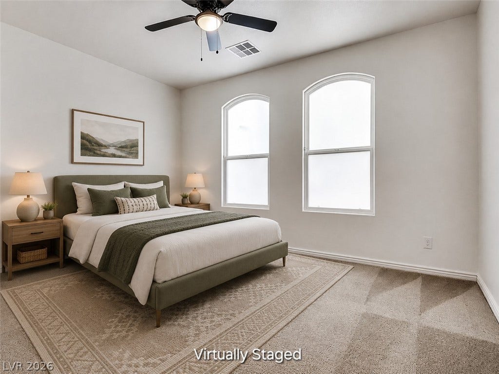 4709 Estate Ranch Street, North Las Vegas, NV 89031 Natural light pours into this peaceful bedroom featuring plush carpeting and a modern ceiling fan.