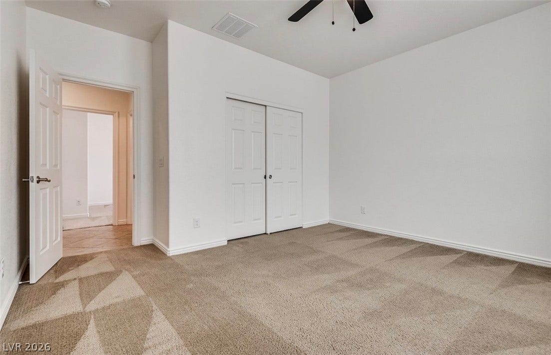 4709 Estate Ranch Street, North Las Vegas, NV 89031 A well-lit bedroom provides ample space for personal furnishings and boasts plush carpeting.