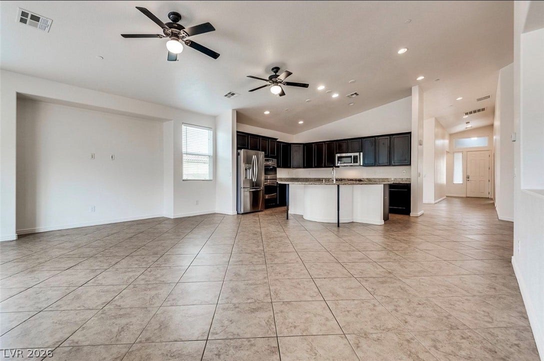 4709 Estate Ranch Street, North Las Vegas, NV 89031 An open floorplan seamlessly connects the living area with a well-appointed kitchen, ideal for modern living.