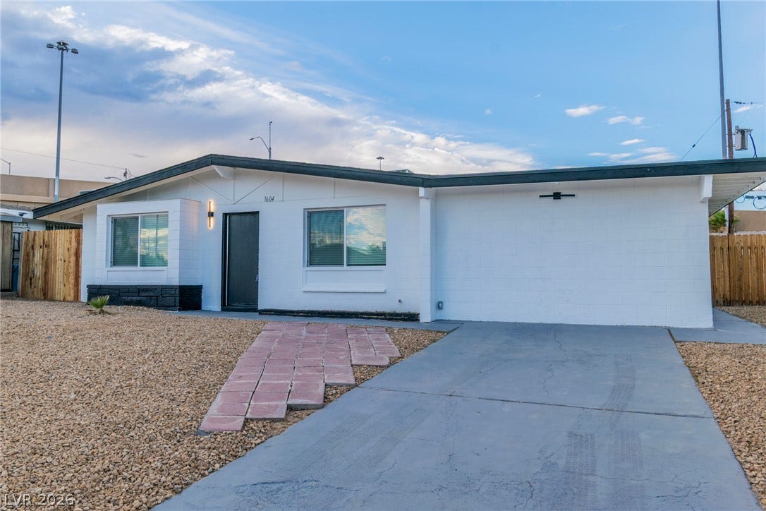 1604 Basswood Avenue, North Las Vegas, NV 89030 A classic low-profile facade features neat gravel landscaping, a solid driveway, and an inviting walkway.