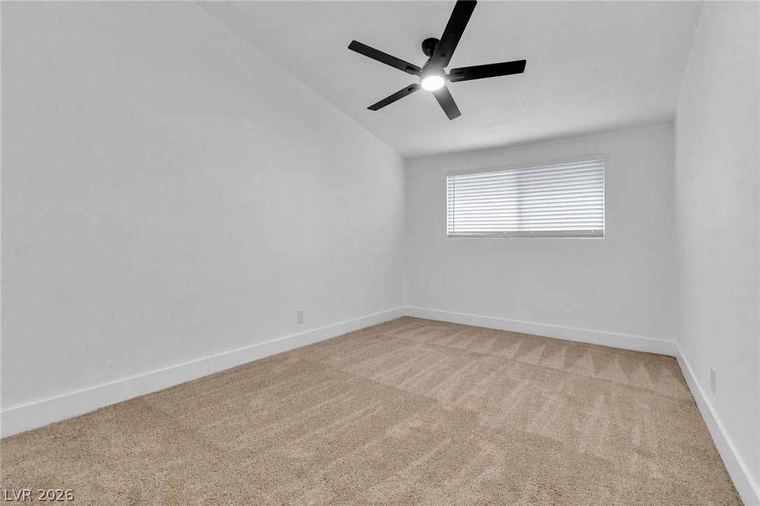 1604 Basswood Avenue, North Las Vegas, NV 89030 Plush carpeting and a wide window create a comfortable and inviting atmosphere.
