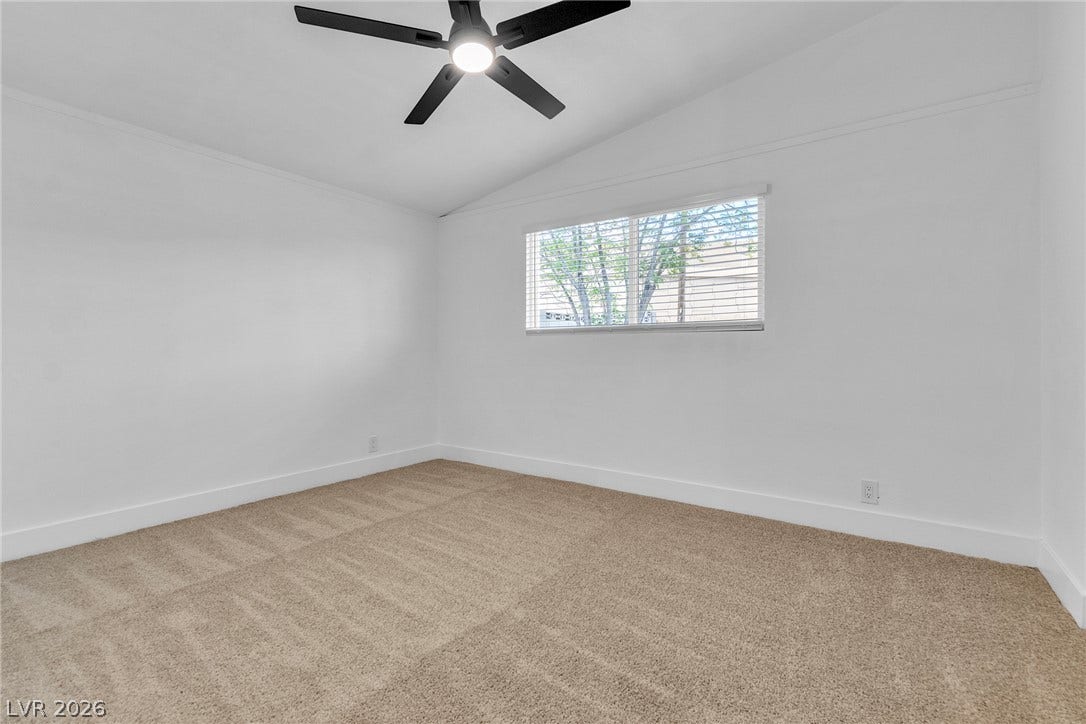 1604 Basswood Avenue, North Las Vegas, NV 89030 Vaulted ceilings and plush carpeting define this airy bedroom space.