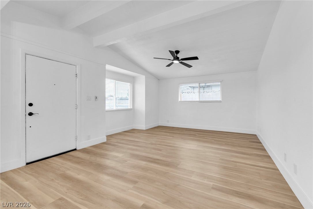 1604 Basswood Avenue, North Las Vegas, NV 89030 Warm wood flooring grounds this airy living space detailed with clean architectural lines.