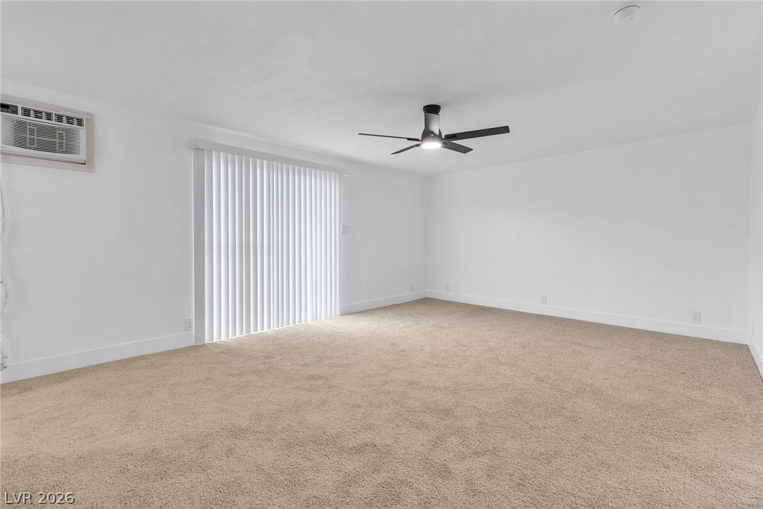 1604 Basswood Avenue, North Las Vegas, NV 89030 Plush carpeting and a large sliding glass door define this versatile living space.