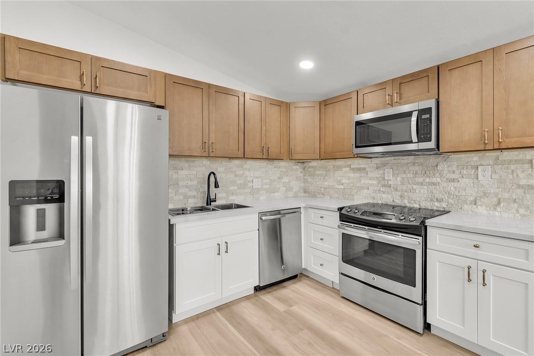 1604 Basswood Avenue, North Las Vegas, NV 89030 Modern cabinetry and stone tile backsplashes complement clean quartz countertops and integrated steel appliances.