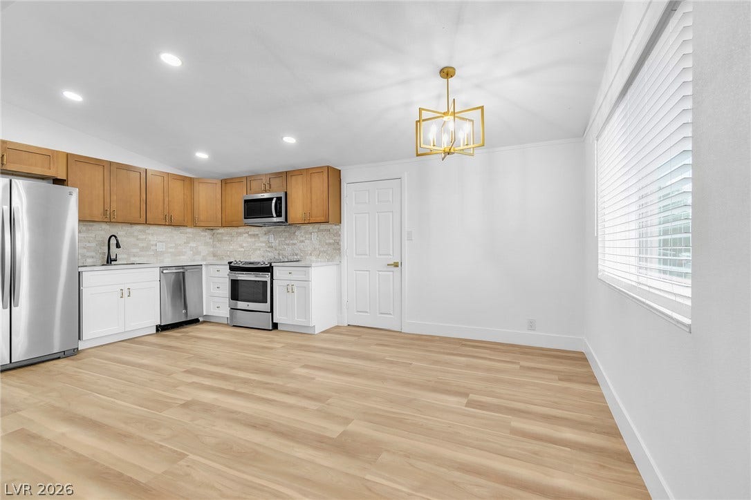 1604 Basswood Avenue, North Las Vegas, NV 89030 Warm wood cabinetry and durable vinyl plank flooring define this functional kitchen and dining space.