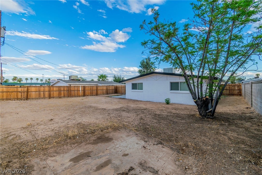 1604 Basswood Avenue, North Las Vegas, NV 89030 An expansive backyard space surrounded by fencing offers endless possibilities for outdoor customization.