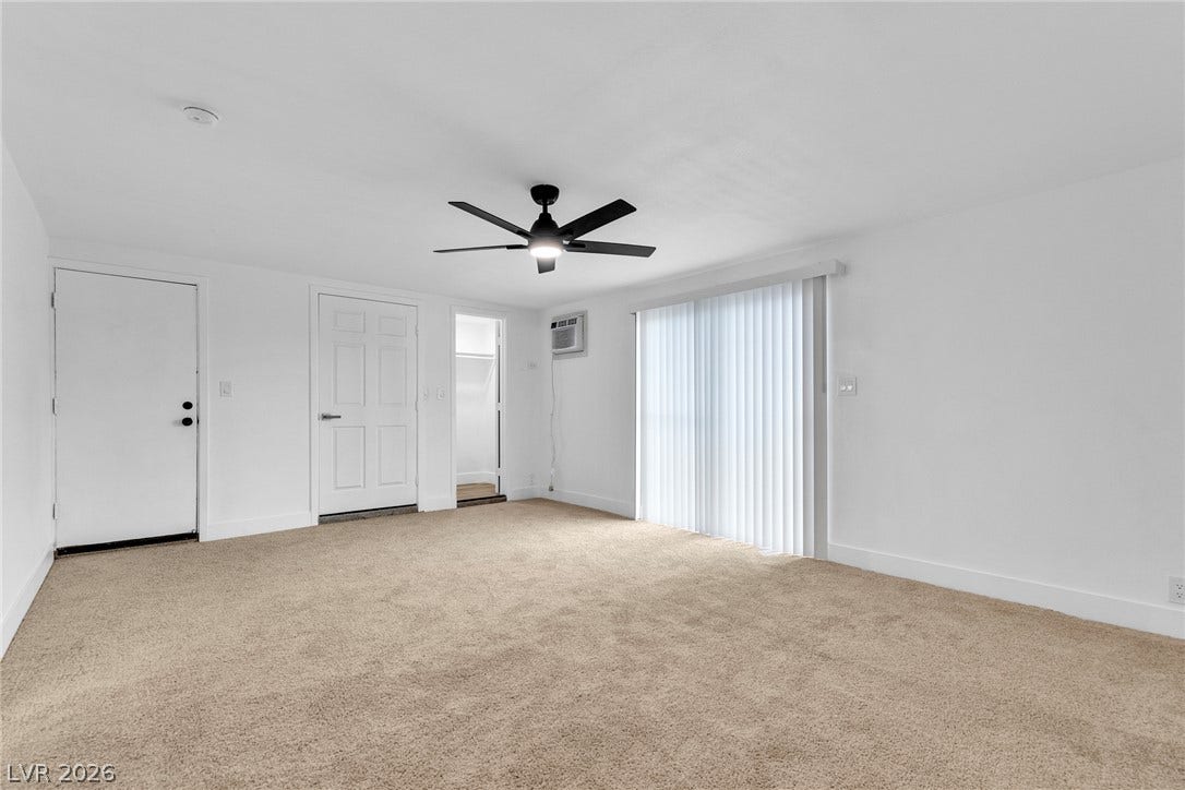 1604 Basswood Avenue, North Las Vegas, NV 89030 Glass sliding doors open to the outdoors from this carpeted living area.