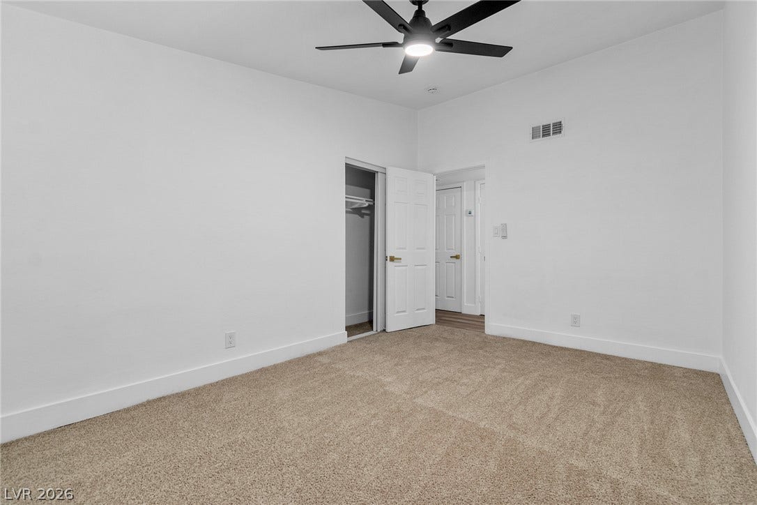 1604 Basswood Avenue, North Las Vegas, NV 89030 Plush carpeting and towering high ceilings define this versatile, minimalist interior space.