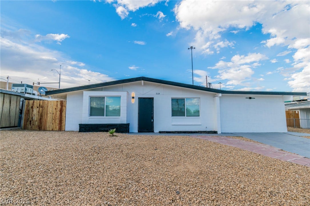 1604 Basswood Avenue, North Las Vegas, NV 89030 Clean architectural lines and low-maintenance desert landscaping define this modern single-story exterior.