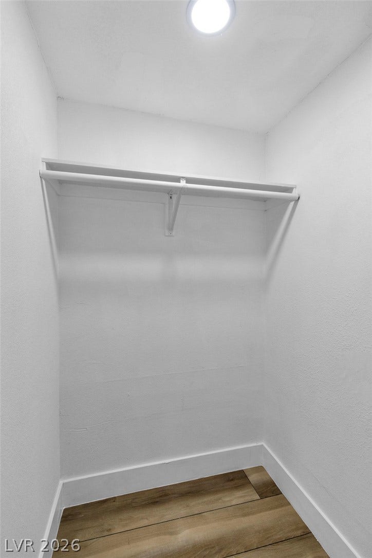 1604 Basswood Avenue, North Las Vegas, NV 89030 Ample storage awaits in this functional closet featuring overhead shelving and wood-look flooring.