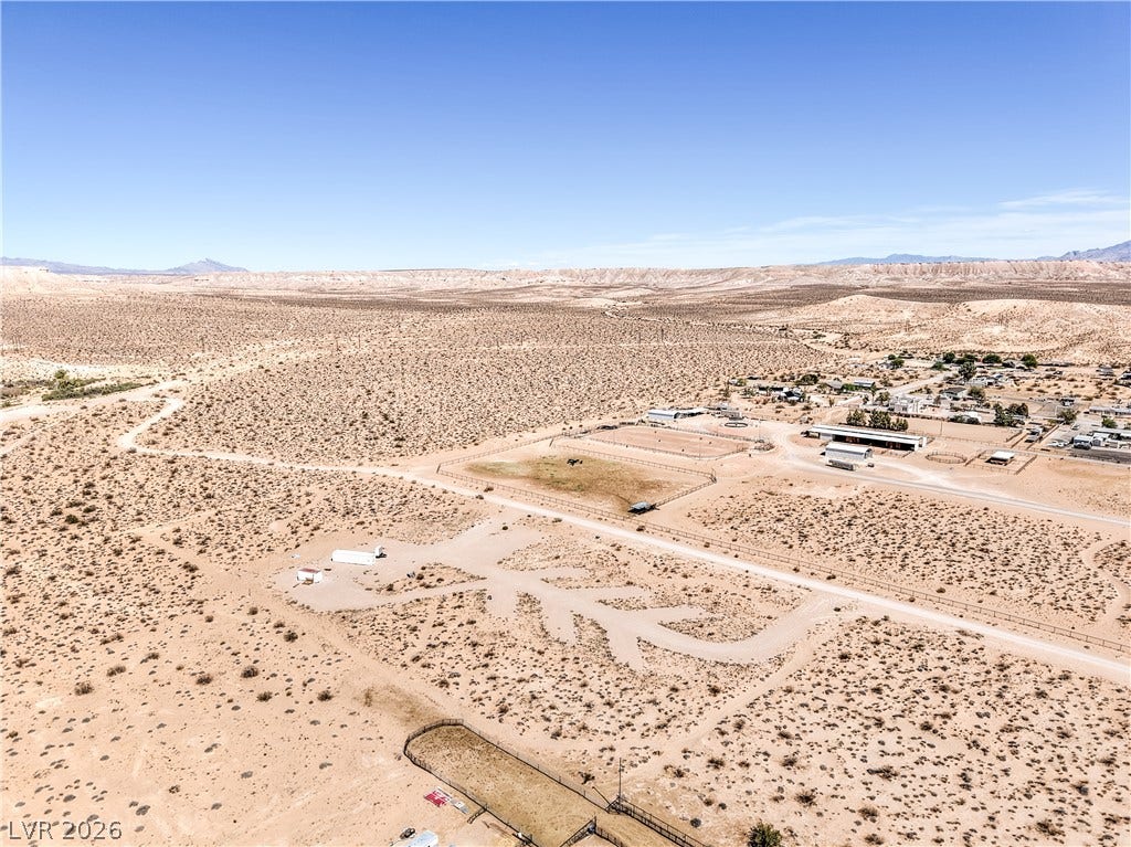 Skyline, Logandale, NV 89021 An aerial perspective showcases a vast desert landscape with mountains lining the distant horizon.