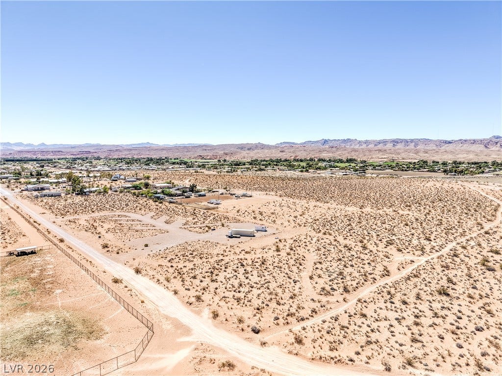 Skyline, Logandale, NV 89021 Rugged mountain ridges frame this expansive desert terrain under a clear blue sky.