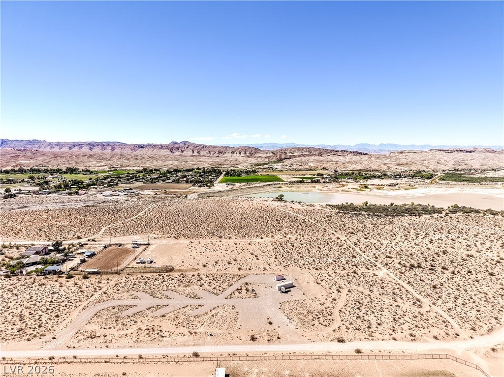 Skyline, Logandale, NV 89021 Vast desert acreage unfolds toward distant mountain ranges under a clear sky.