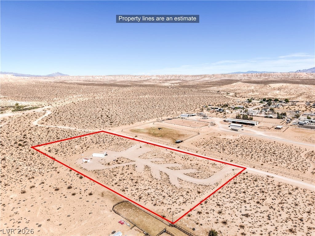 Skyline, Logandale, NV 89021 An aerial perspective showcases a spacious desert lot framed by mountain views.