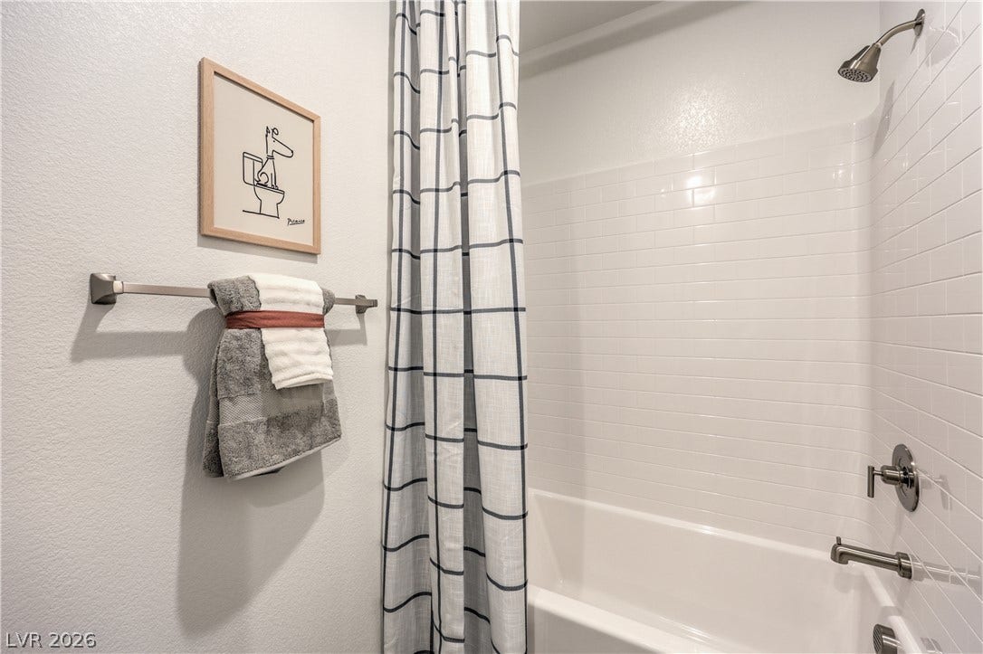 844 Kassie Lake Way, North Las Vegas, NV 89084 Clean subway tile surrounds the tub shower combination in this updated bathroom. Representational only; Photo is of the 2660 Plan Model Home - NOT THE ACTUAL HOME FOR SALE *material/features/colors can vary from one community to the next & are subject to change*