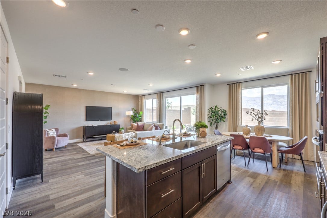 844 Kassie Lake Way, North Las Vegas, NV 89084 Gleaming stone countertops and wood flooring anchor this seamless, open-concept living area. Representational only; Photo is of the 2660 Plan Model Home - NOT THE ACTUAL HOME FOR SALE *material/features/colors can vary from one community to the next & are subject to change*