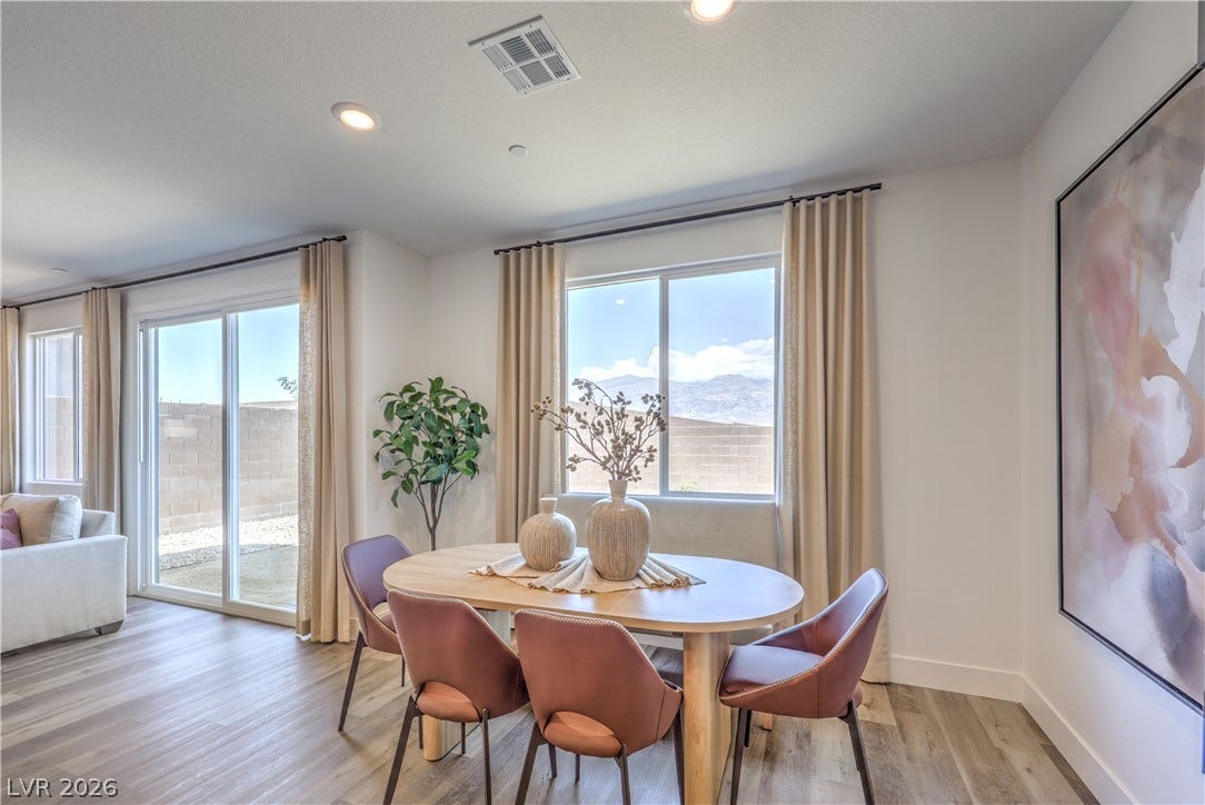 844 Kassie Lake Way, North Las Vegas, NV 89084 Natural light pours through large windows onto smooth plank flooring in this inviting dining space. Representational only; Photo is of the 2660 Plan Model Home - NOT THE ACTUAL HOME FOR SALE *material/features/colors can vary from one community to the next & are subject to change*