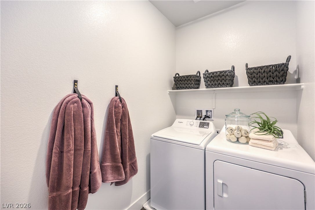 844 Kassie Lake Way, North Las Vegas, NV 89084 Streamlined utility area features integrated washer and dryer hookups alongside functional built-in shelving. Representational only; Photo is of the 2660 Plan Model Home - NOT THE ACTUAL HOME FOR SALE *material/features/colors can vary from one community to the next & are subject to change*