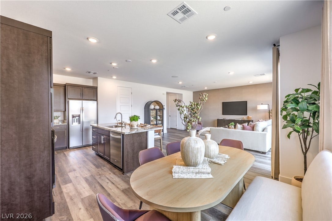 844 Kassie Lake Way, North Las Vegas, NV 89084 A spacious open-concept floor plan connects the modern kitchen with the dining and living areas. Representational only; Photo is of the 2660 Plan Model Home - NOT THE ACTUAL HOME FOR SALE *material/features/colors can vary from one community to the next & are subject to change*