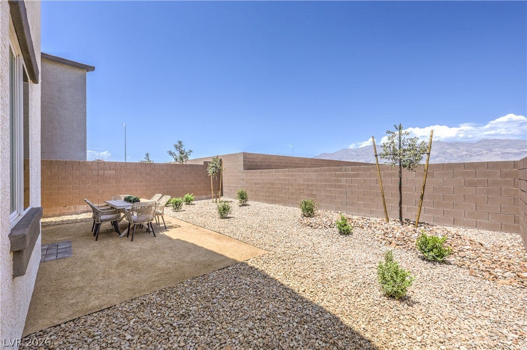844 Kassie Lake Way, North Las Vegas, NV 89084 An enclosed backyard features gravel landscaping, a solid block wall, and scenic mountain views. Representational only; Photo is of the 2660 Plan Model Home - NOT THE ACTUAL HOME FOR SALE *material/features/colors can vary from one community to the next & are subject to change*