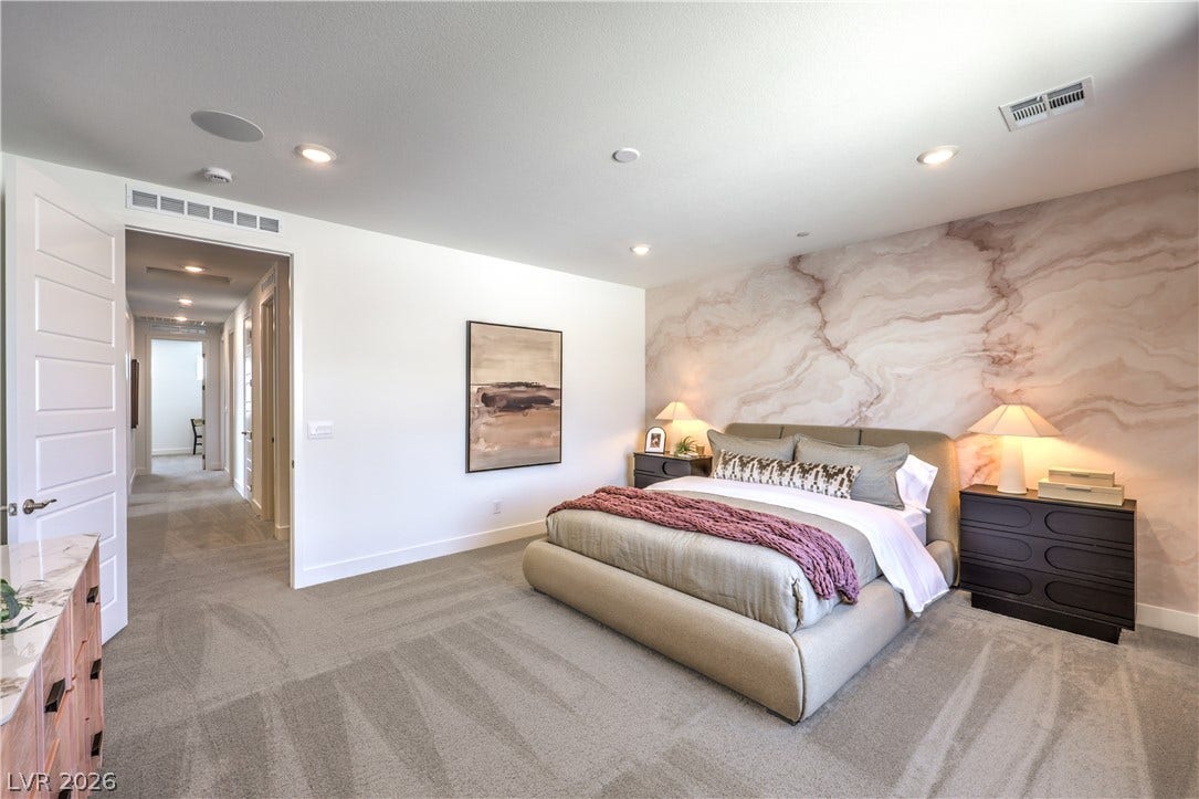 844 Kassie Lake Way, North Las Vegas, NV 89084 Recessed lighting and wall-to-wall carpeting define this peaceful sleeping space.