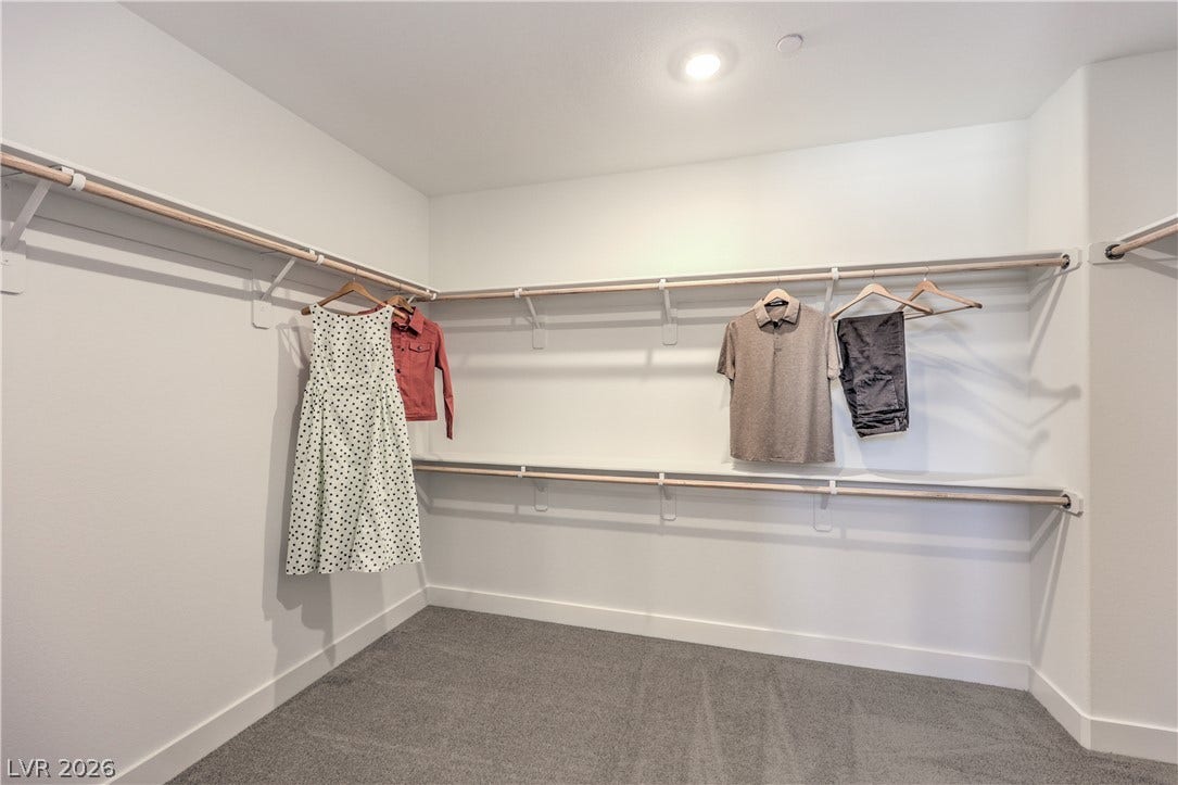 844 Kassie Lake Way, North Las Vegas, NV 89084 A spacious walk-in closet includes ample hanging space and soft carpeting. Representational only; Photo is of the 2660 Plan Model Home - NOT THE ACTUAL HOME FOR SALE *material/features/colors can vary from one community to the next & are subject to change*
