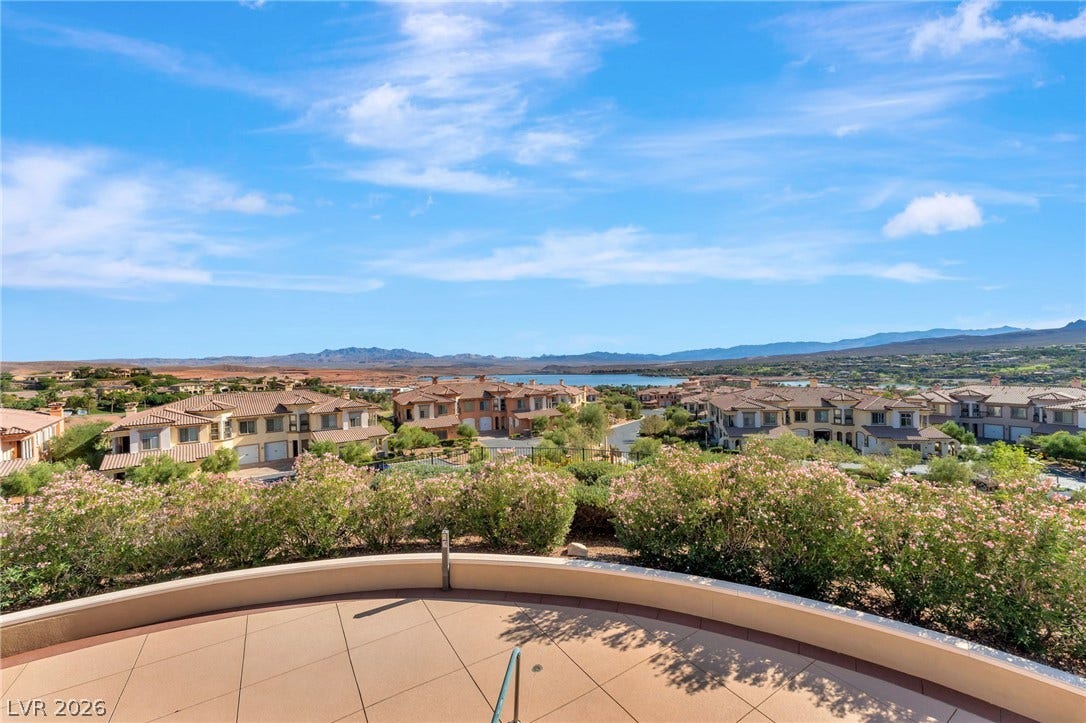 30 Via Vasari, #103, Henderson, NV 89011 Sweeping neighborhood and mountain vistas unfold from this elevated tiled terrace under a wide sky.